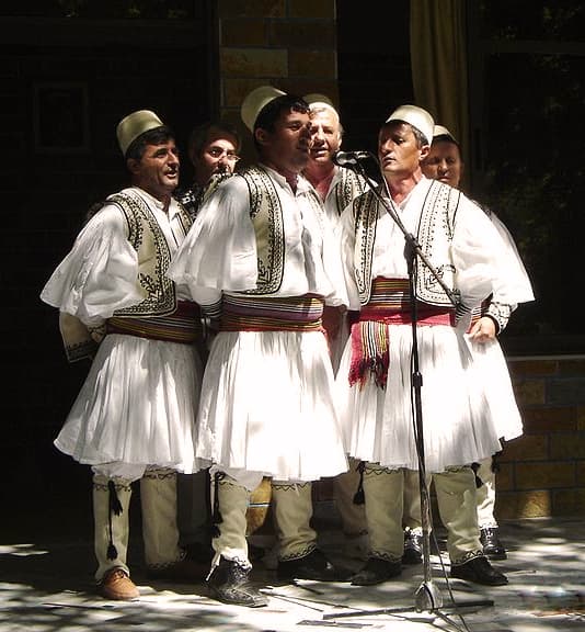 A circle of southern Albanian singers in traditional clothes performing iso-polyphony