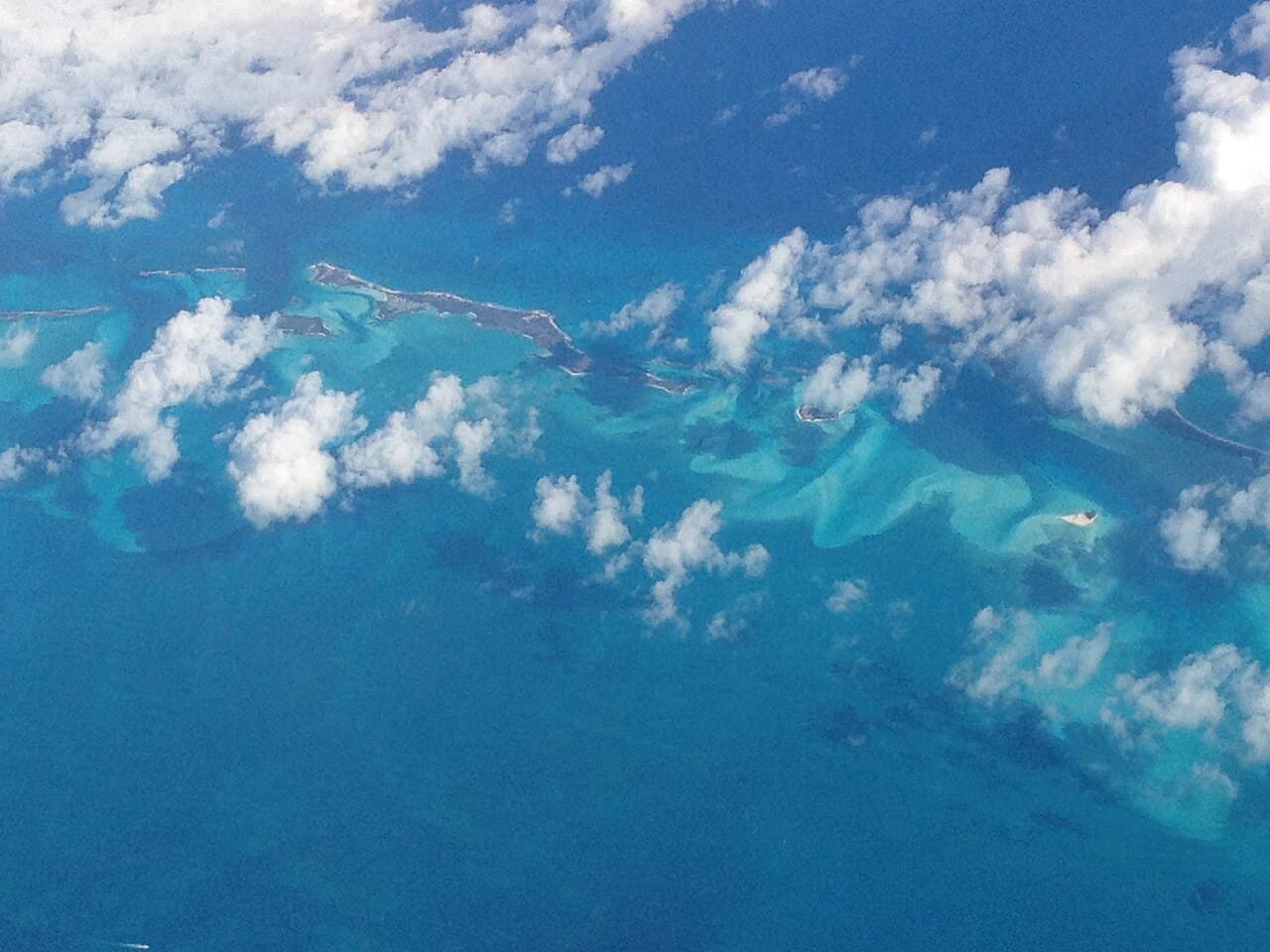Aerial view of turquoise Bahamian waters with small green islands