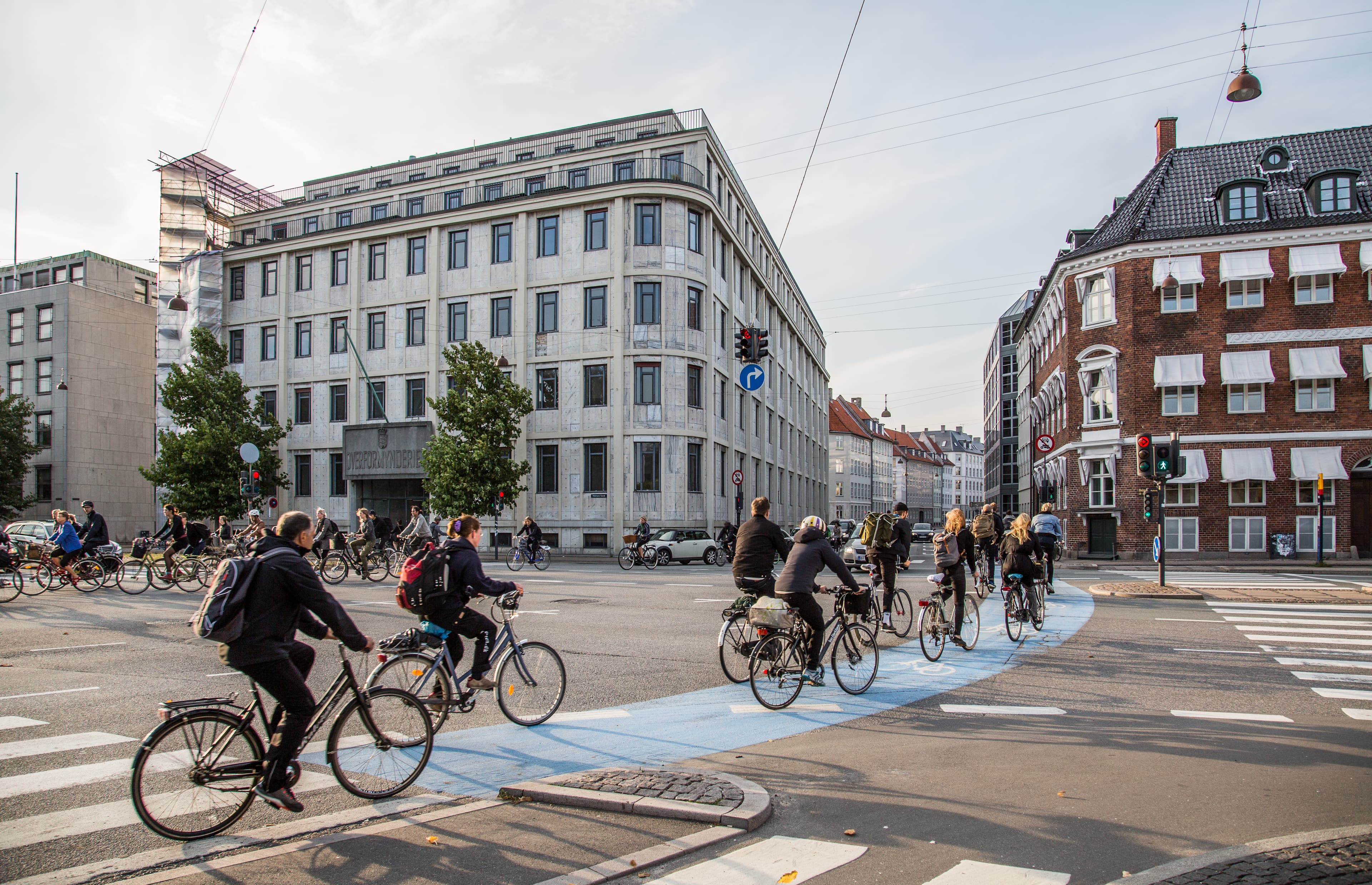 Bicycles parked in a long row beside a canal in Copenhagen