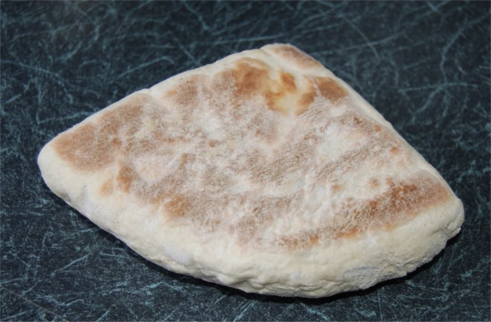 A round loaf of Irish soda bread with a cross cut into the top