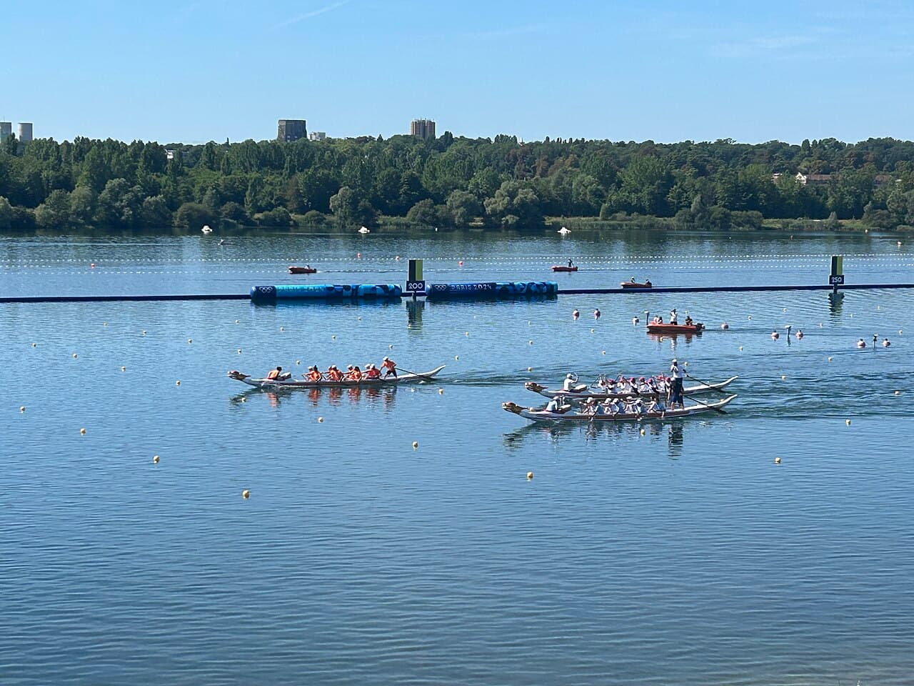 Dragon boat racing team paddling hard in a colourful painted dragon boat on the water
