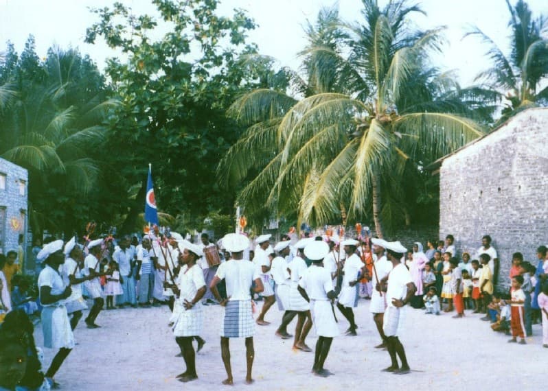 Men playing large cylindrical drums at a traditional bodu beru performance
