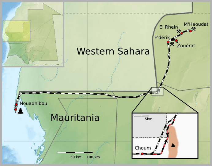 The Mauritanian iron-ore train stretching across the desert with wagons full of dark ore
