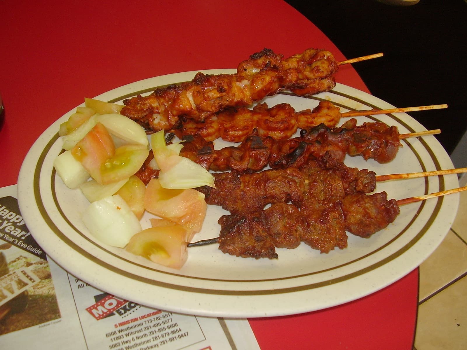Suya - skewers of grilled spiced meat on a plate