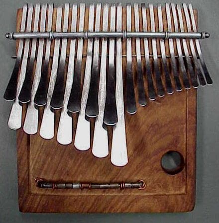 A traditional Zimbabwean mbira instrument with metal tines on a wooden board