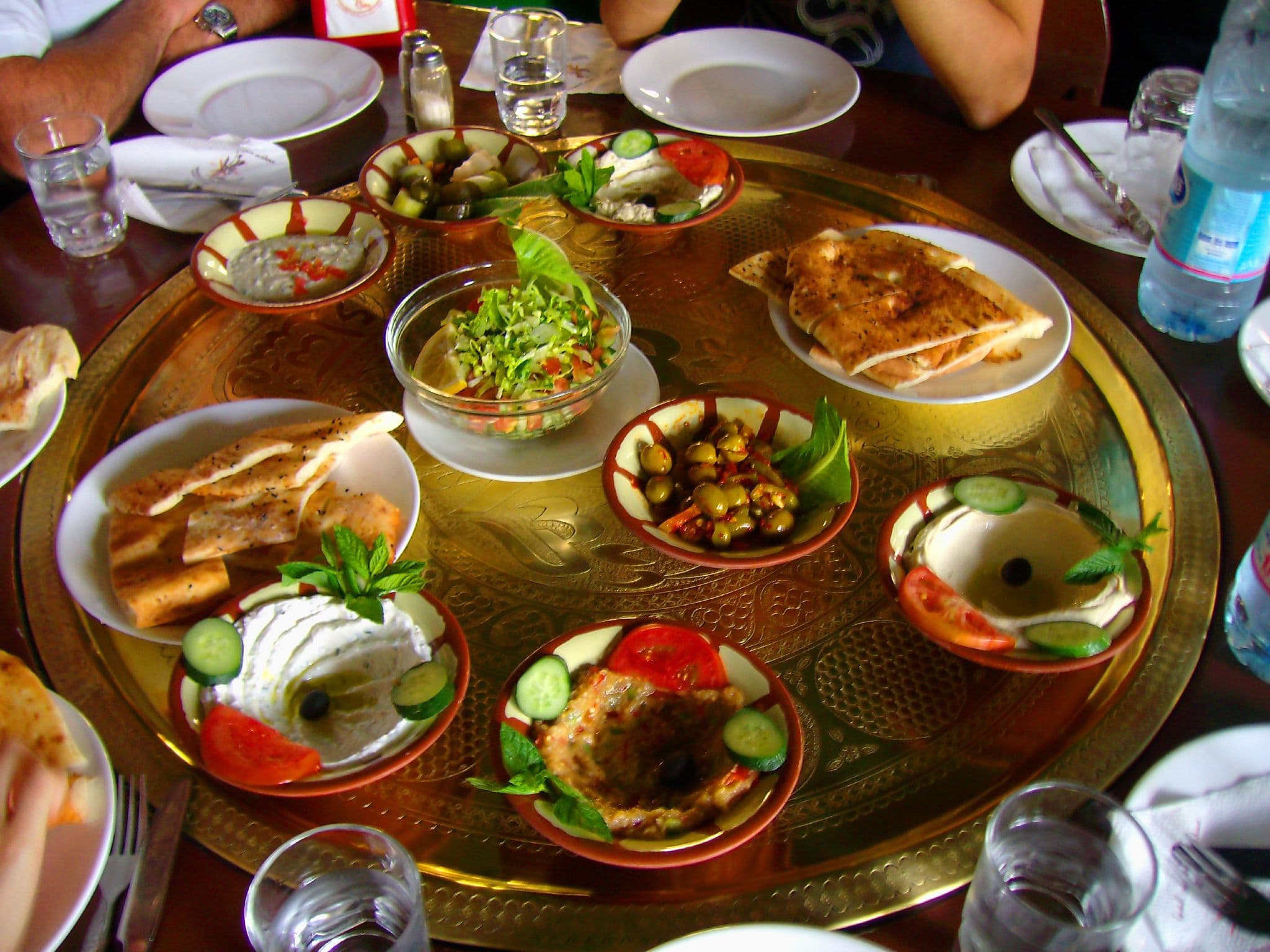 A long table covered with small bowls of Lebanese mezze