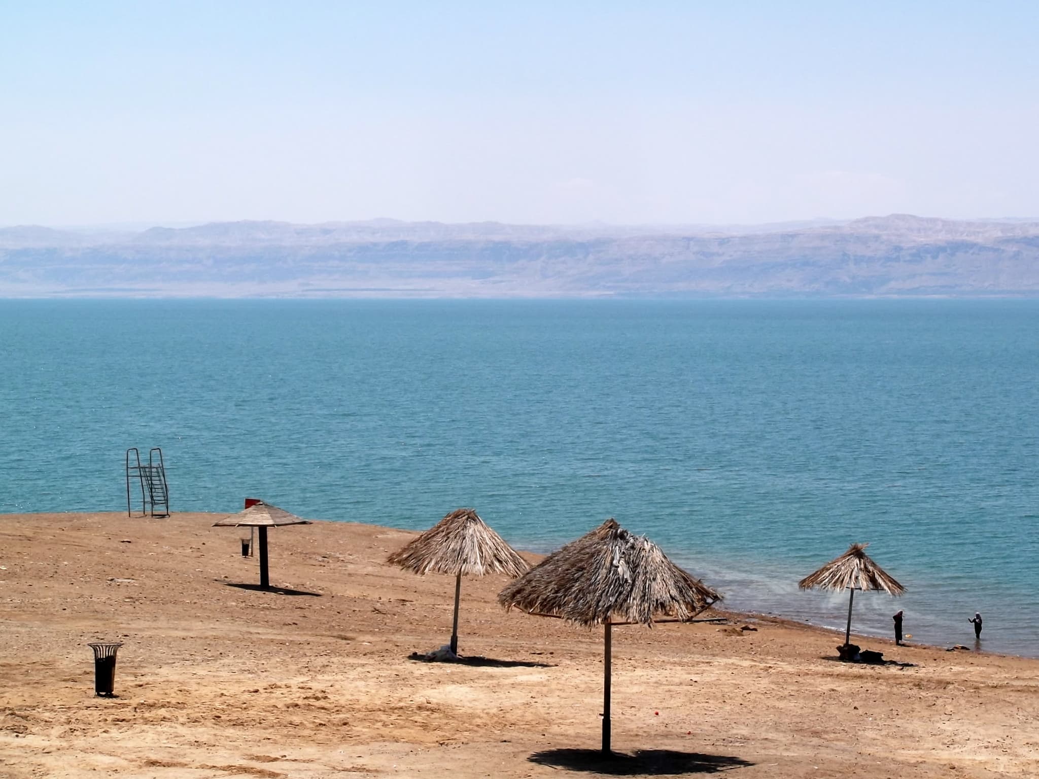 A person floating effortlessly on the glassy surface of the Dead Sea